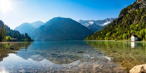 Bergsee Panorama mit Bergen und Spiegelung im See am Morgen